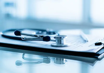 Stethoscope on top of form and clipboard